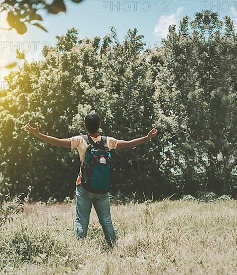 Backpacker man in the forest spreading his arms, Backpacker man in the forest spreading his arms