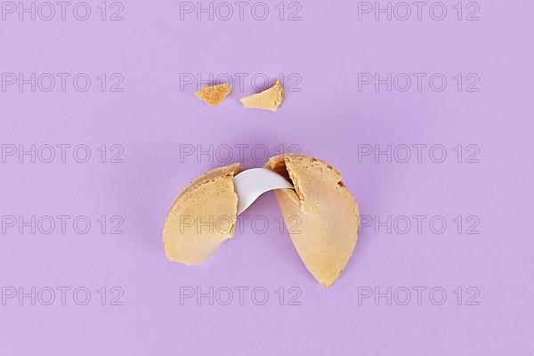 Cracked fortune cookie with note without text,
