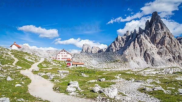 Mountain hut Dreizinnenhuette with hiking trail and chapel, on the right rock massif Paternkofel