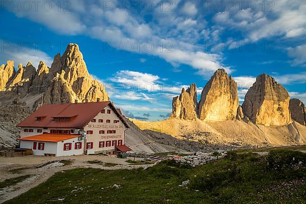 View of mountain hut Dreizinnenhuette with rock massif Paternkofel and mountain range drei Zinnen, panorama