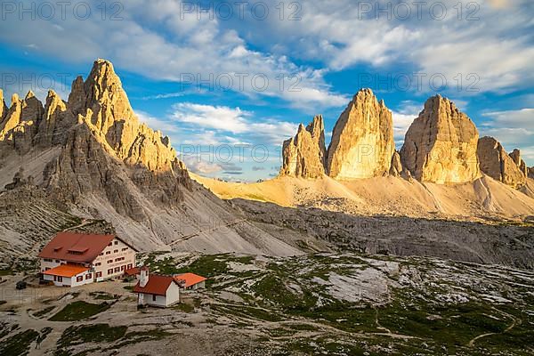 View of mountain hut Dreizinnenhuette and chapel with rock massif Paternkofel and mountain range drei Zinnen, panorama