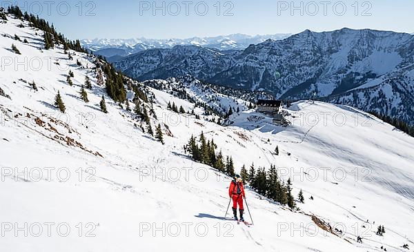 Ski tourers on ski tour on the Rotwand, behind mountain hut Rotwandhaus with mountain panorama