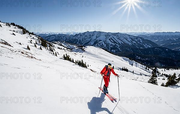 Ski tourers on ski tour on the Rotwand, behind mountain hut Rotwandhaus with mountain panorama