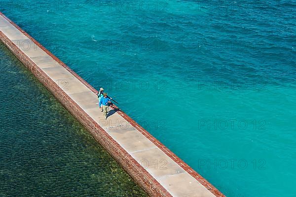 Tourists walking on a Pier surrounding Fort Jefferson, Dry Tortugas National Park