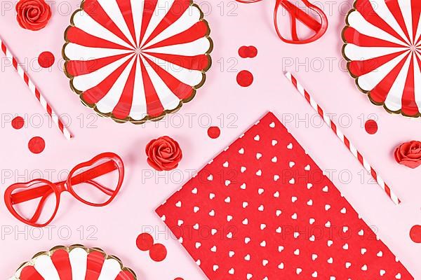 Party flat lay with paper plates, heart shaped glasses