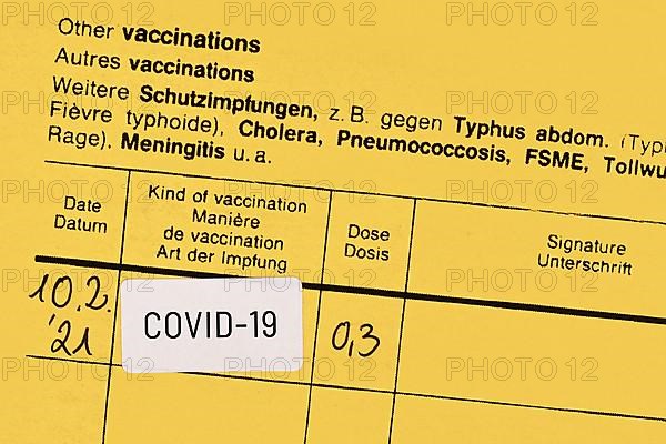 Certificate of vaccination with COVID-19 vaccine sticker,
