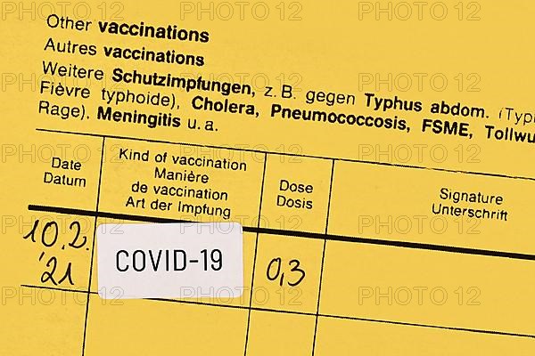 Certificate of vaccination with COVID-19 vaccine sticker,