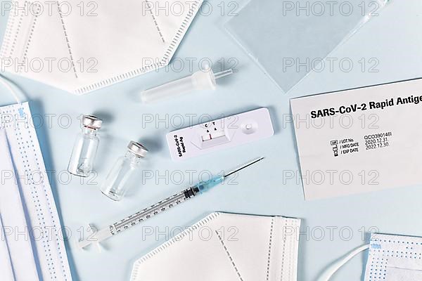 Fight Corona Virus pandemic with tools like rapid antigen test, medical face masks and vaccine vials with syringe