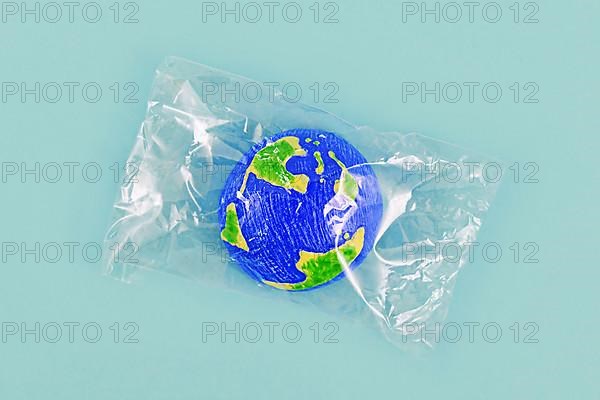 Small planet earth model wrapped in plastic,