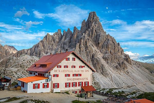 Mountain hut Dreizinnenhuette at dusk, in the background rock massif Paternkofel