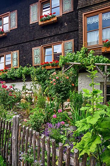 Wooden shingle facade with cottage garden, Hindelang