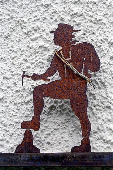 Iron rusty climber in front of house wall, Hindelang