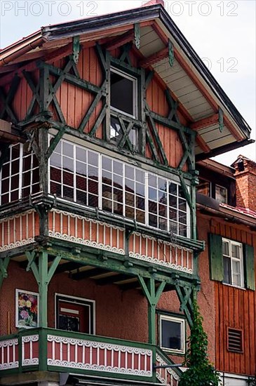 Old wooden facade with half-timbering and balconies, Hindelang