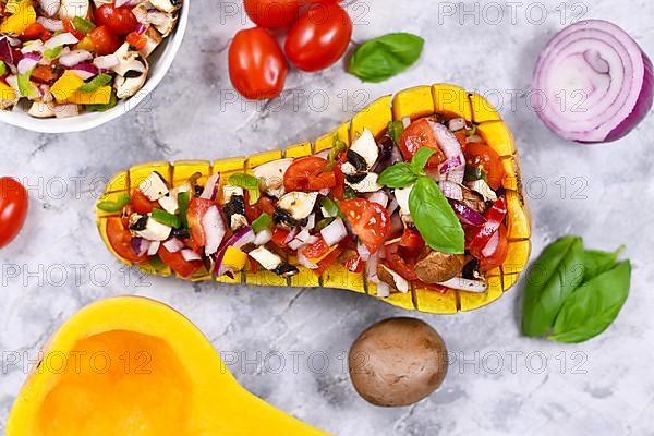 Top view of vegan baked Butternut squash vegetable filled bell pepper, cherry tomatoes