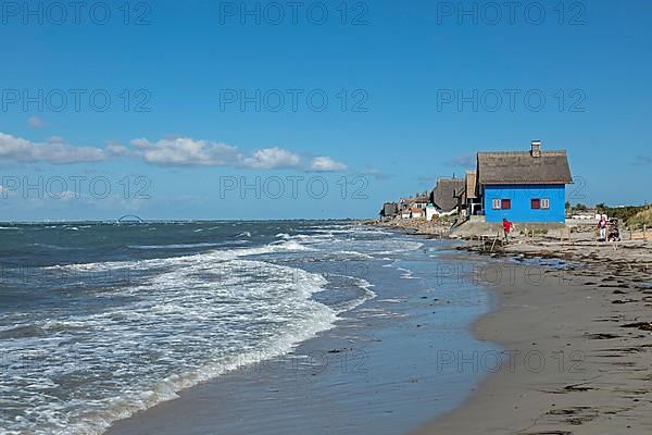 Thatched roof houses on the beach, Fehmarnsund Bridge