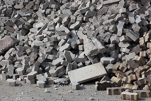 Demolition of an old paved area of an industrial wasteland, torn out paving stones