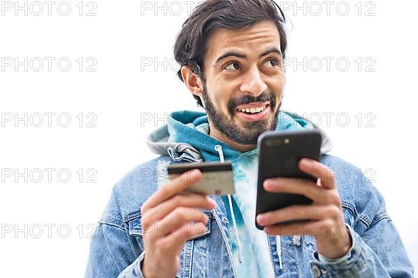 Latin man using credit card to make online payment on smartphone. mixed-race man using cellphone for shopping online. Guy using smart phone to check credit card transactions from app. White background,