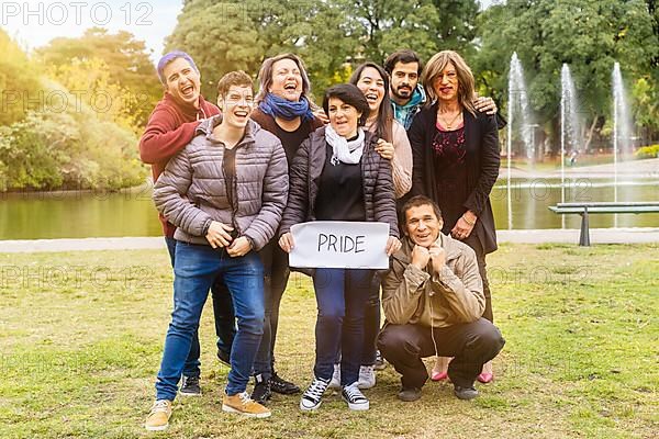 Pride. Cheerful queer group holding a message supporting the LGBT community,