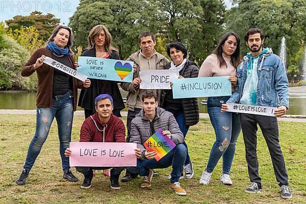 Cheerful queer group holding a message supporting the LGBT community,