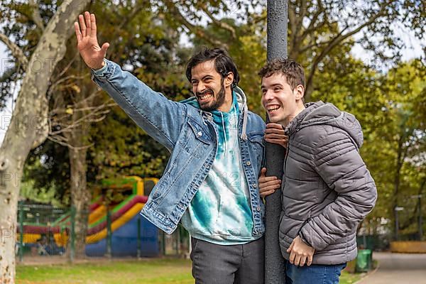 Latin gay couple having fun at a park,