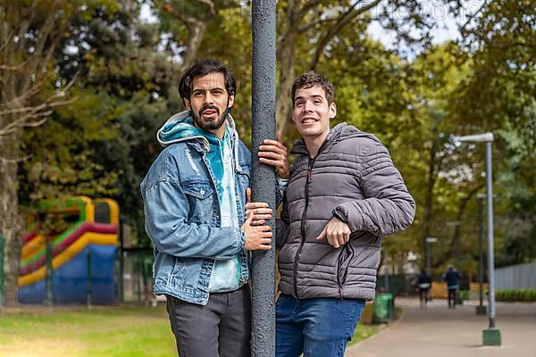 Latin gay couple having fun at a park,