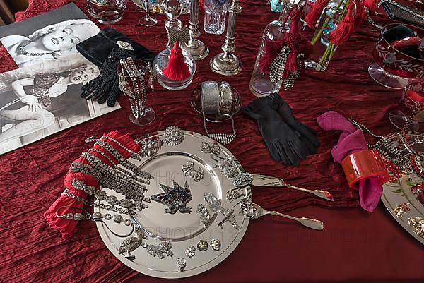 Rhinestone jewellery and accessories decorated on a silver plate and red cloth, Bavaria