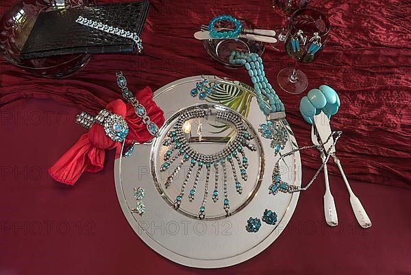 Rhinestone jewellery and accessories decorated on a silver plate and red cloth, Bavaria