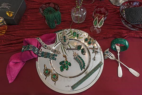 Rhinestone jewellery and accessories decorated on a silver plate and red cloth, Bavaria