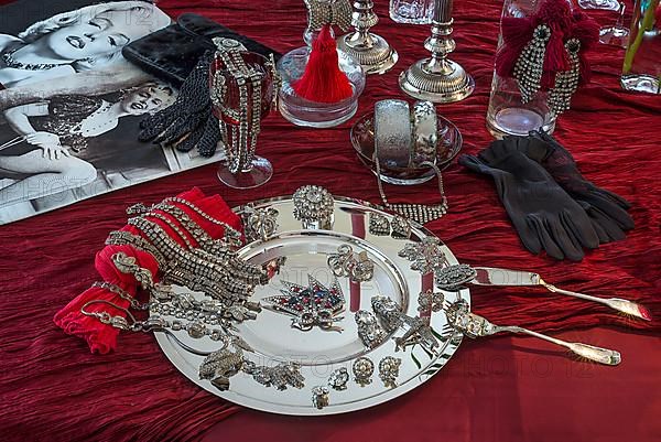 Rhinestone jewellery and accessories decorated on a silver plate and red cloth, Bavaria