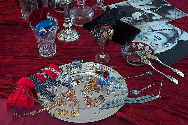 Rhinestone jewellery and accessories decorated on a silver plate and red cloth, Bavaria