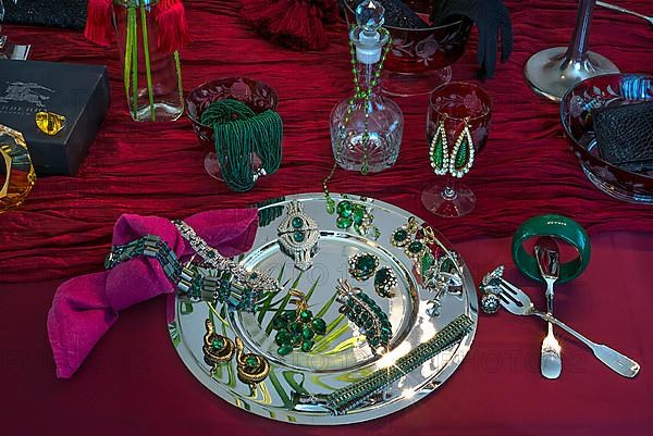 Rhinestone jewellery and accessories decorated on a silver plate and red cloth, Bavaria