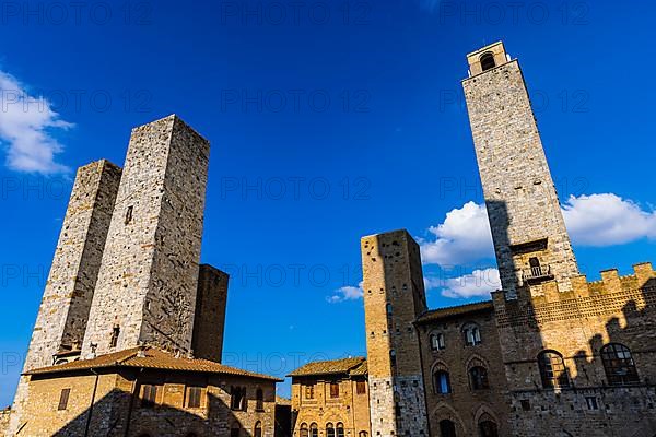 Gender towers and medieval buildings against a blue sky, San Gimignano