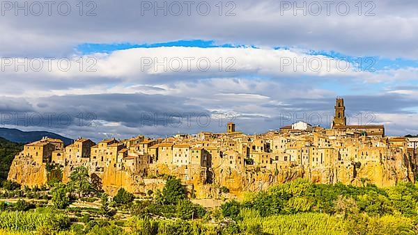 Panoramic view of the medieval town of Pitigliano, dark clouds above