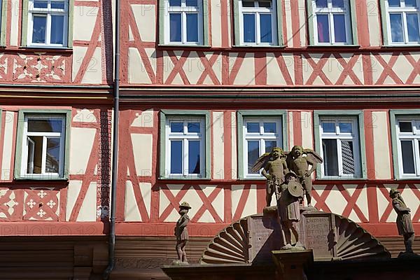 Half-timbered house with fountain in Wertheim am Main, Baden-Wuerttemberg