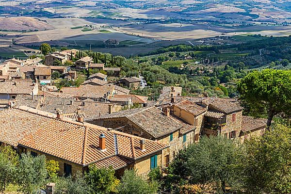 Above the rooftops of Montalcino, view of the Val dOrcia valley