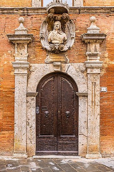 Historic round arched house entrance gate of a palace, framed with columns of light marble