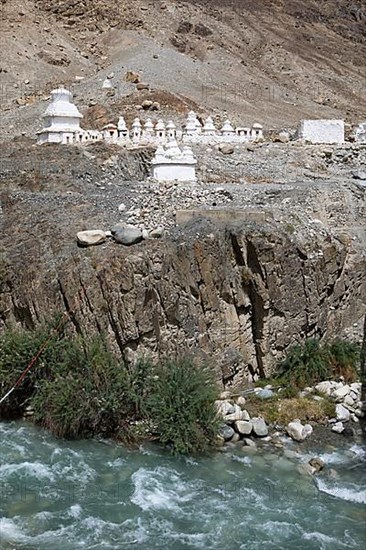 Small white stupa on the mountainside, Nubra River below