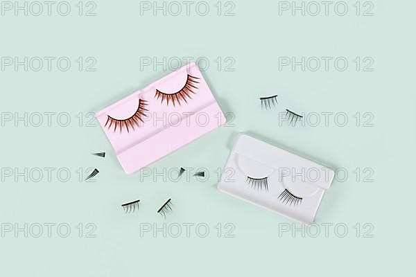 Different false lashes on mint green background,