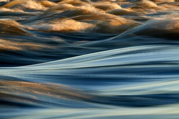 Zambezi River rapids with the golden light of African sunset, close-up photographed long exposure to display motion
