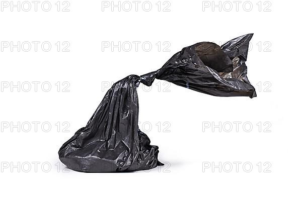 Black plastic dog poop bag on white background,
