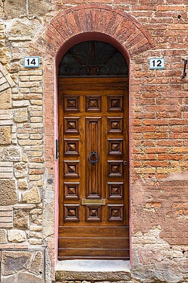 Ornate round arch front door, Montalcino