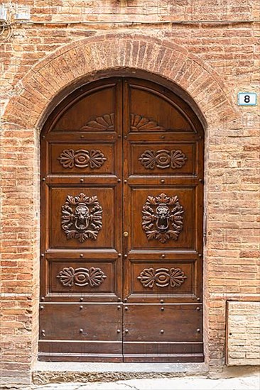 Ornate round arch front door, Montalcino