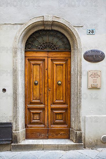 Ornate round arch front door, Montalcino