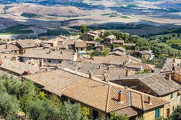 Above the rooftops of Montalcino, view of the Val dOrcia valley