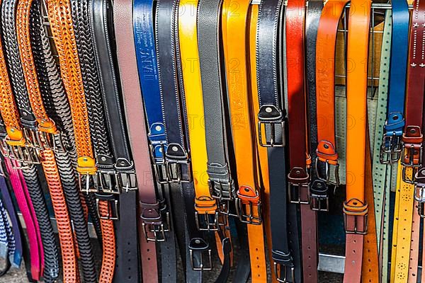 Coloured belts at a stall at the weekly market market in Buonconvento, Val dOrcia