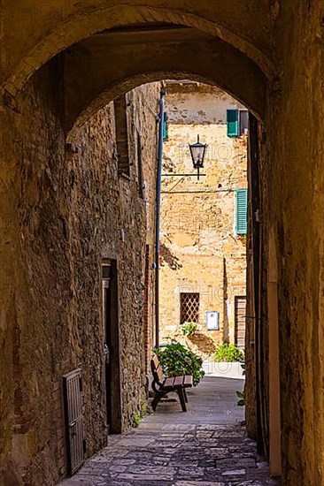 Archway and old stone houses in Monticchiello, Tuscany