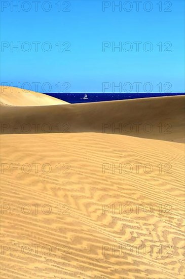 The dunes of Playa Del Ingles with a view of the Atlantic Ocean. San Bartolome de Tirajana, Gran Canaria