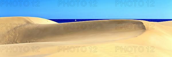 The dunes of Playa Del Ingles with a view of the Atlantic Ocean. San Bartolome de Tirajana, Gran Canaria