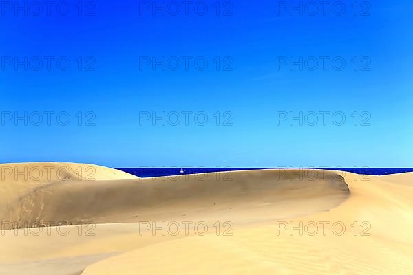 The dunes of Playa Del Ingles with a view of the Atlantic Ocean. San Bartolome de Tirajana, Gran Canaria