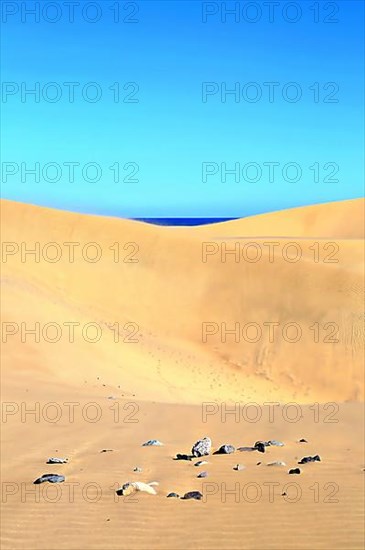 The dunes of Playa Del Ingles with a view of the Atlantic Ocean. San Bartolome de Tirajana, Gran Canaria